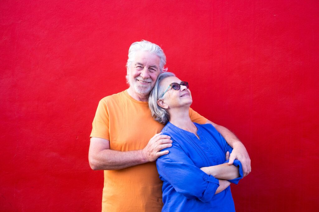 couple of seniors having fun together and smiling - mature man looking at the camera