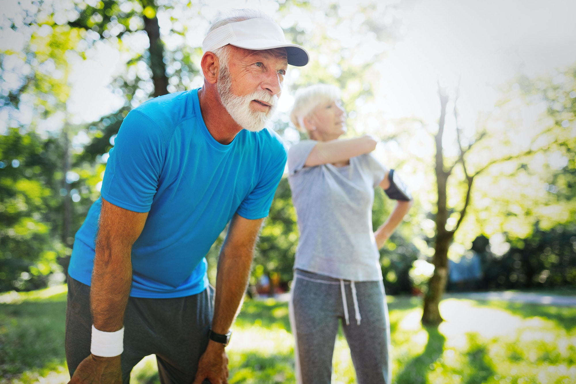 Mature couple jogging and running outdoors in nature