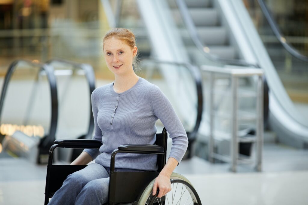 Young woman in wheelchair in shopping mall