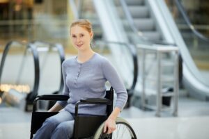 Young woman in wheelchair in shopping mall