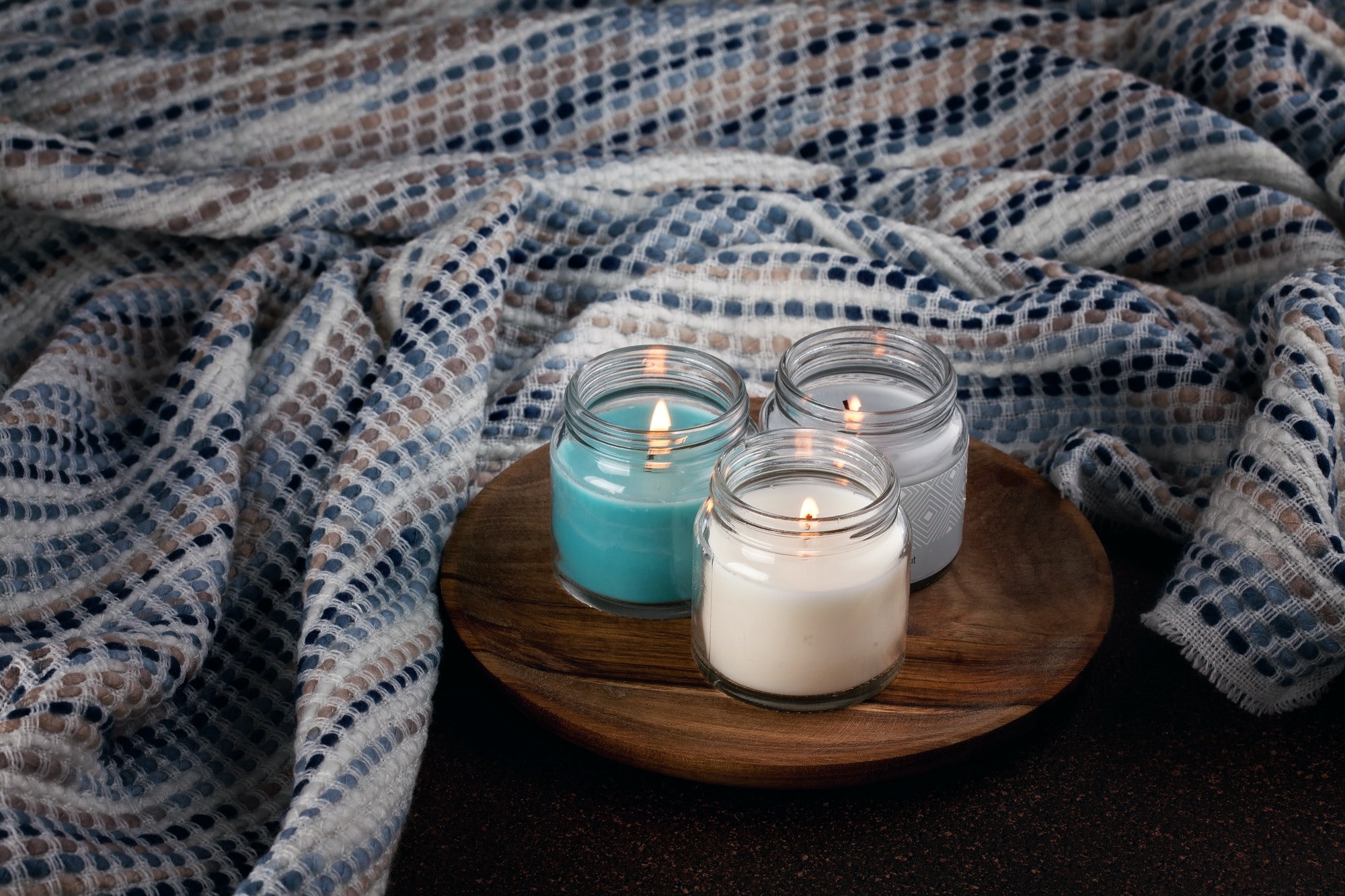 Candles for cold weather. Cosy winter evening or winter holidays celebration concept