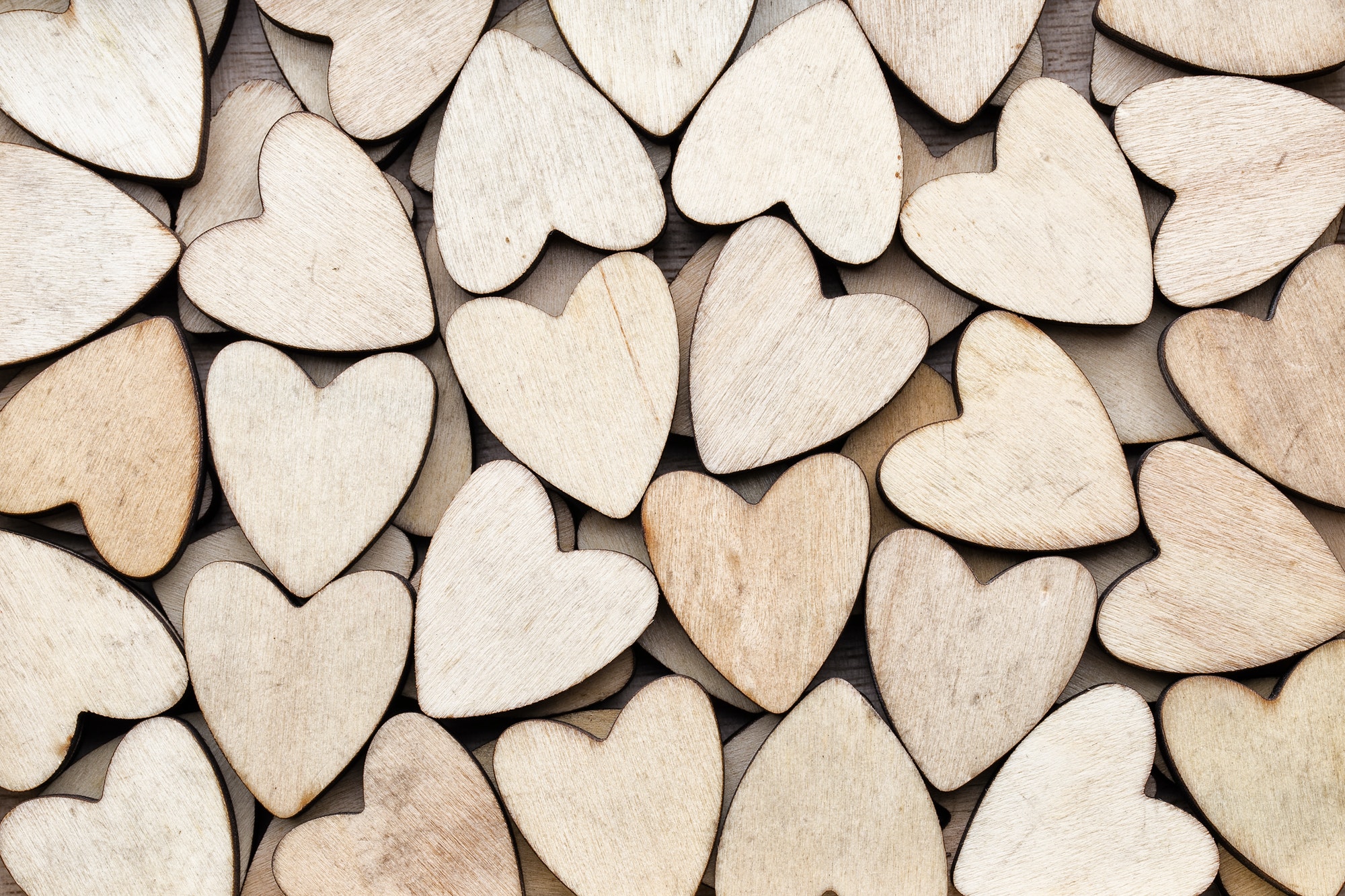 Wooden hearts, on the heart background.