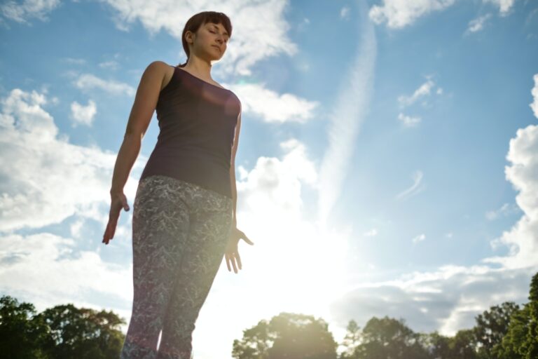 Yoga outdoor in park. Woman doing yoga exercises.Mountain yoga pose tadasana.