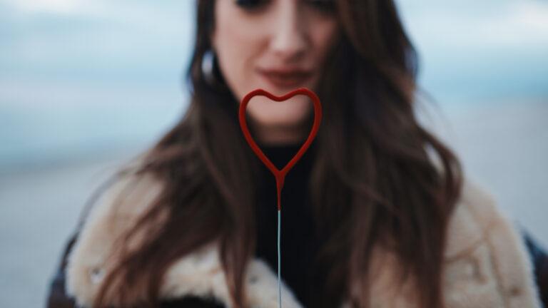 Woman With Red Heart In Hands