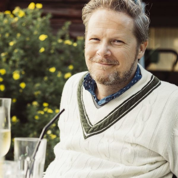 Portrait of mature man sitting at table in garden