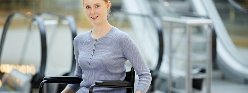 Young woman in wheelchair in shopping mall